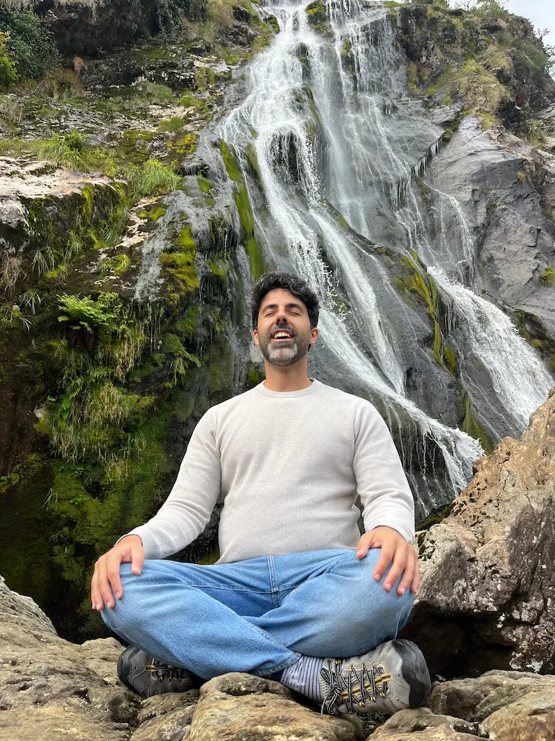 João Matos, Human Design Coach, meditating by a waterfall
